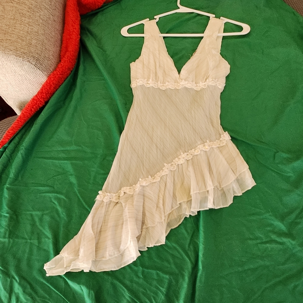 Cream colored top w sequence.  Size small